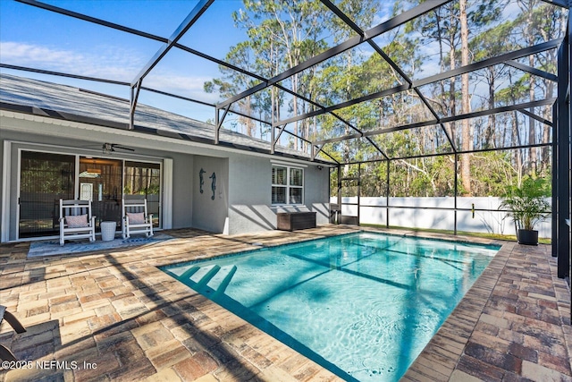 view of pool featuring a fenced in pool, a lanai, a patio, and a ceiling fan