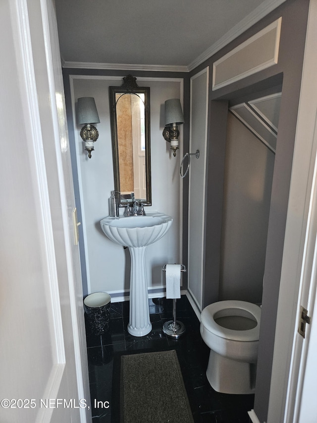 half bathroom with crown molding and toilet