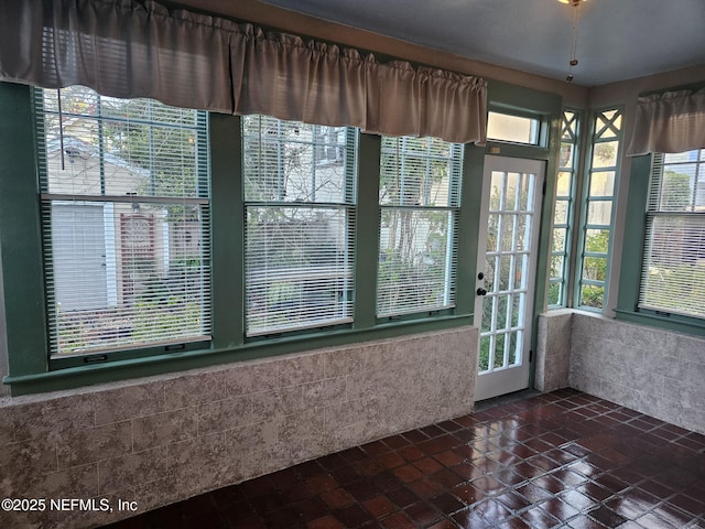 unfurnished sunroom with a healthy amount of sunlight