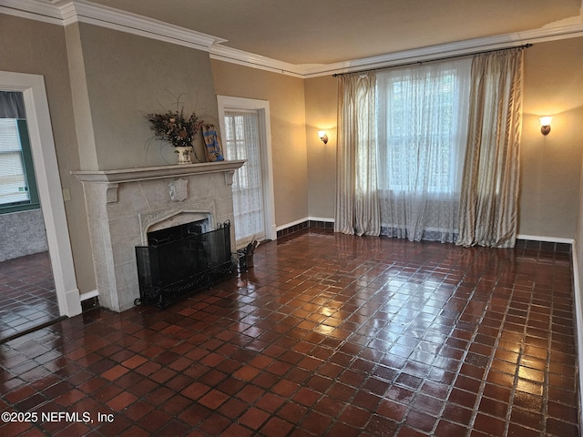 unfurnished living room with a fireplace, crown molding, and baseboards