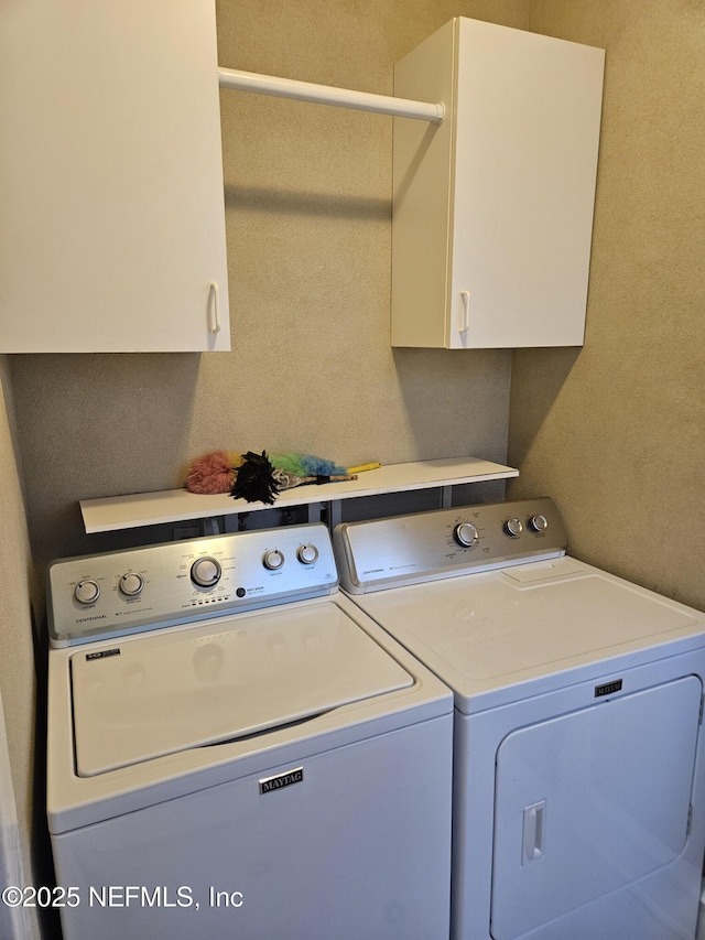 laundry room featuring cabinet space and washing machine and dryer