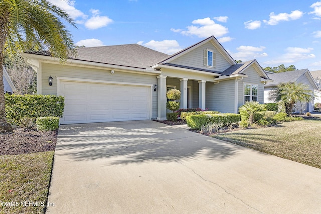 view of front of house with an attached garage, concrete driveway, and a shingled roof