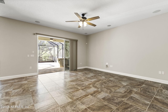 unfurnished room featuring a textured ceiling, baseboards, ceiling fan, and a sunroom