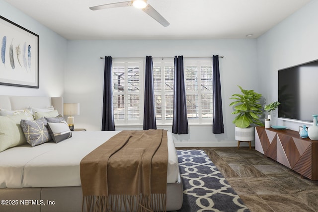 bedroom featuring baseboards and ceiling fan