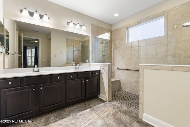 bathroom with a wealth of natural light, a walk in shower, and a sink