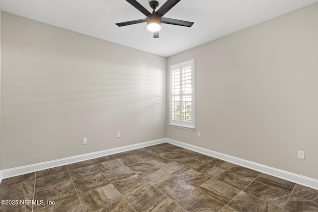 unfurnished room featuring baseboards and a ceiling fan