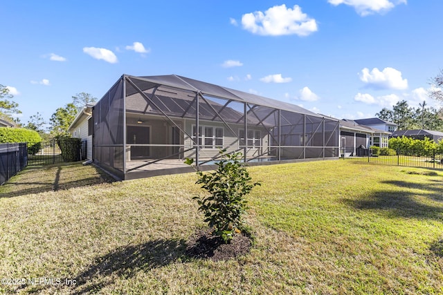 back of property featuring glass enclosure, a patio area, a fenced backyard, and a lawn