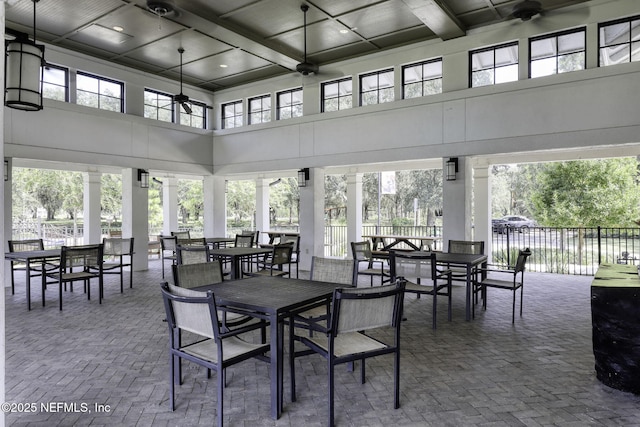 interior space featuring a ceiling fan, outdoor dining area, and fence