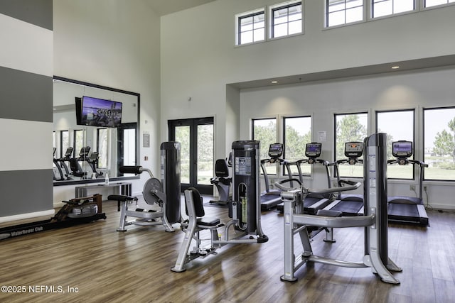 gym with french doors and dark wood-style flooring