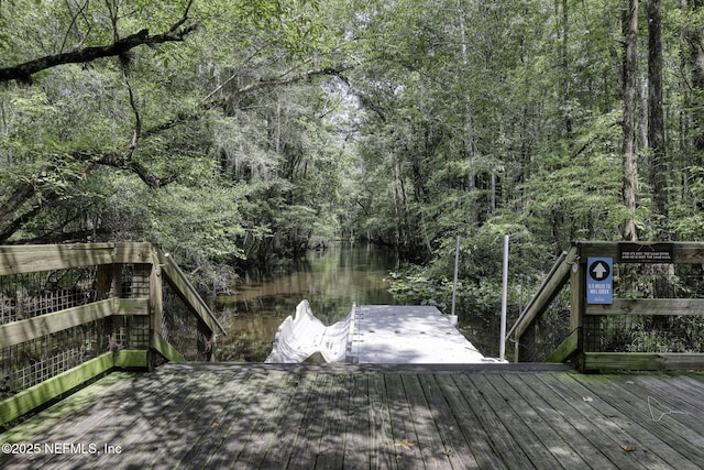 view of dock featuring a wooded view