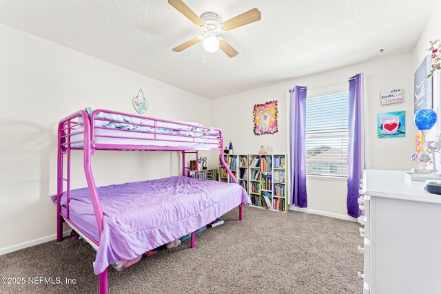 bedroom featuring carpet, baseboards, and a textured ceiling