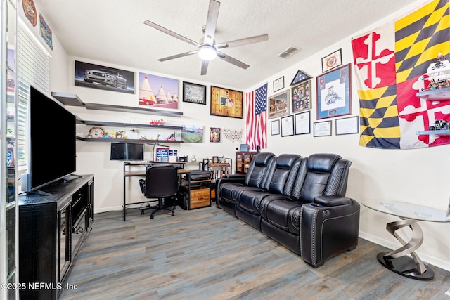 office area featuring ceiling fan, a textured ceiling, visible vents, and wood finished floors