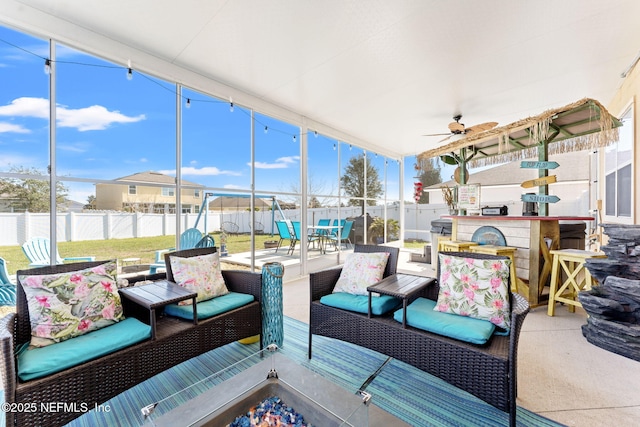 sunroom with a ceiling fan