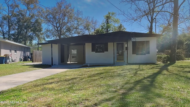 view of front of house featuring a front yard and stucco siding