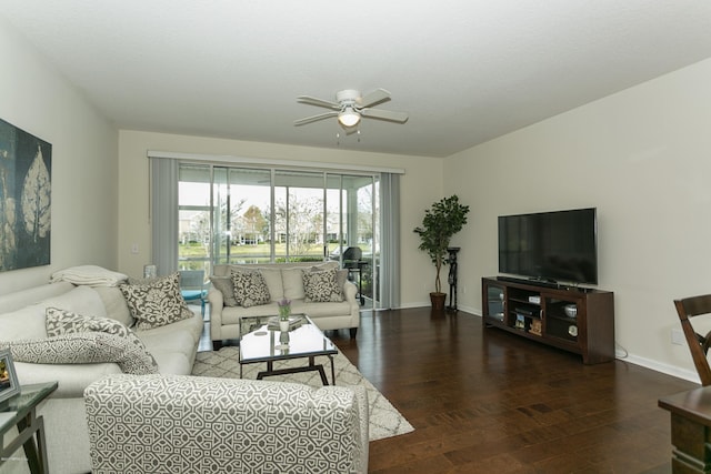 living area featuring baseboards, ceiling fan, and wood finished floors