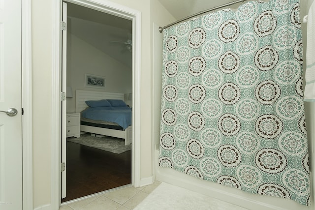 full bathroom with curtained shower and tile patterned flooring