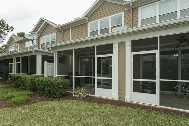 rear view of property with a sunroom