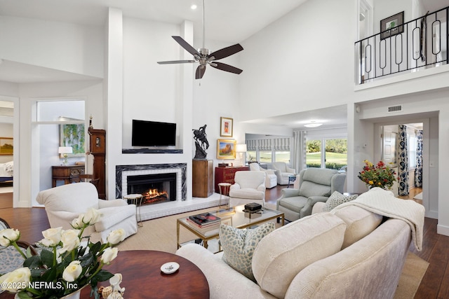 22 Walkers Ridge Dr, Ponte Vedra Beach, FL 32082 - living room featuring high vaulted ceiling, wood finished floors, a ceiling fan, a lit fireplace, and recessed lighting