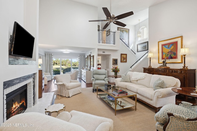 22 Walkers Ridge Dr, Ponte Vedra Beach, FL 32082 - living area with a fireplace, a high ceiling, stairway, ceiling fan, and wood finished floors