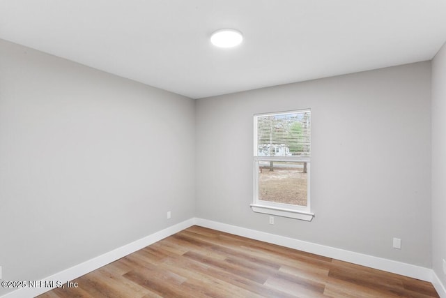 unfurnished room featuring light wood-style flooring and baseboards