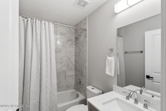 full bathroom with toilet, shower / bath combo, visible vents, and vanity