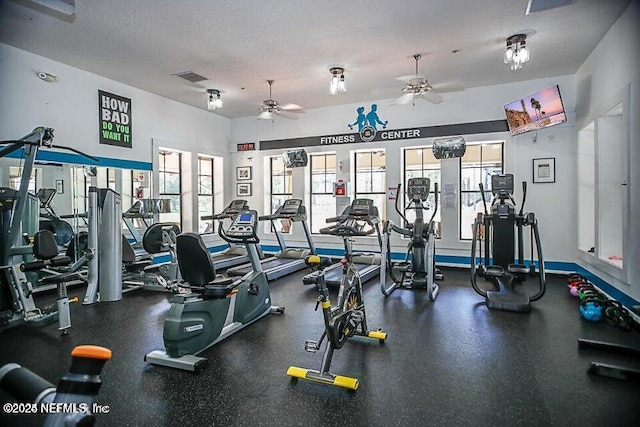 gym featuring a textured ceiling, plenty of natural light, visible vents, and a ceiling fan