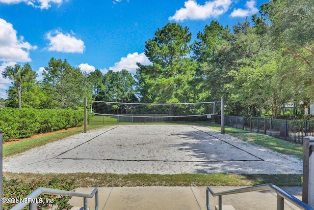 view of community featuring fence and volleyball court