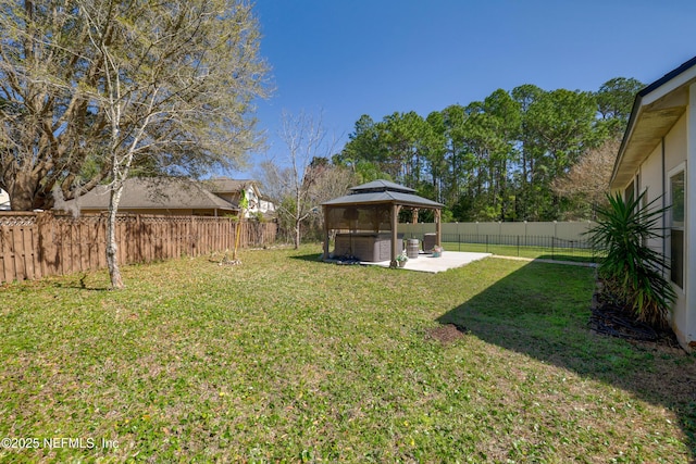 view of yard featuring a patio area, a fenced backyard, and a gazebo