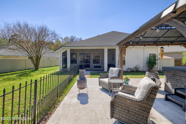 view of patio featuring a fenced backyard, an outdoor living space, a sunroom, a gazebo, and a hot tub