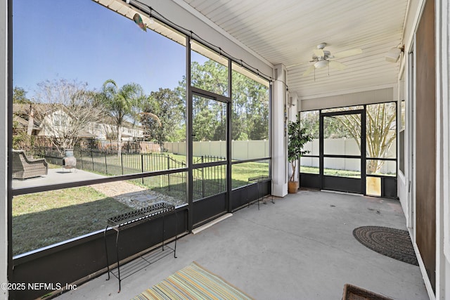 unfurnished sunroom featuring ceiling fan