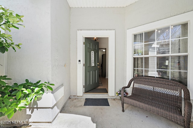 property entrance with stucco siding