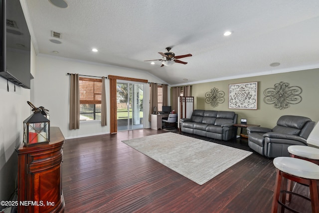 living area featuring lofted ceiling, ceiling fan, ornamental molding, dark wood-style flooring, and a textured ceiling