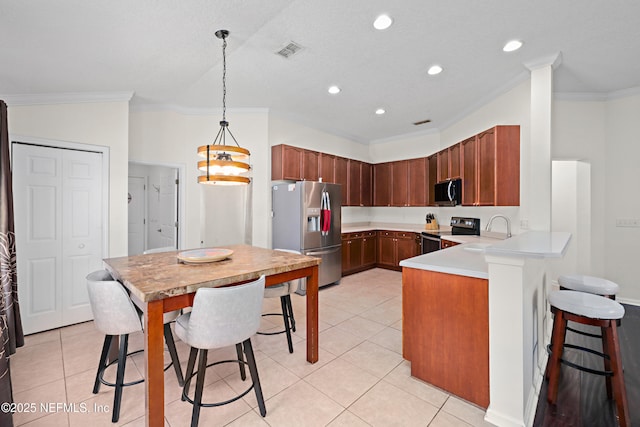 kitchen with stainless steel appliances, a peninsula, a sink, visible vents, and light countertops