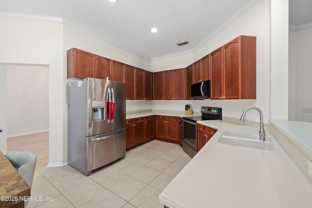 kitchen with light tile patterned floors, visible vents, appliances with stainless steel finishes, crown molding, and a sink