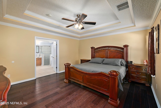 bedroom with a raised ceiling, visible vents, a textured ceiling, baseboards, and hardwood / wood-style flooring