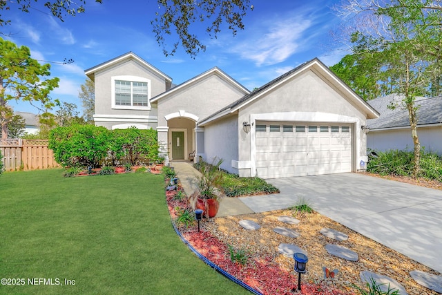 traditional-style house with a garage, fence, driveway, stucco siding, and a front lawn