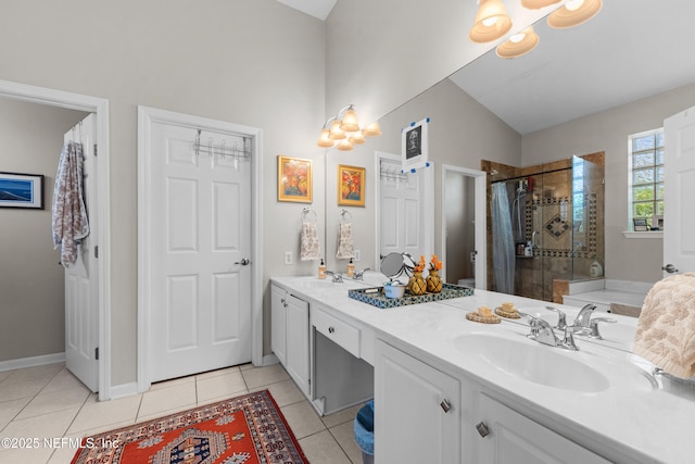 bathroom with tile patterned flooring, a shower stall, vaulted ceiling, and a sink