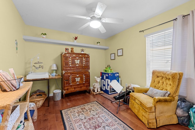 sitting room featuring a ceiling fan and wood finished floors