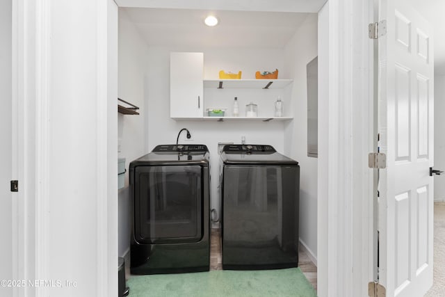 laundry area featuring laundry area, washing machine and dryer, and baseboards