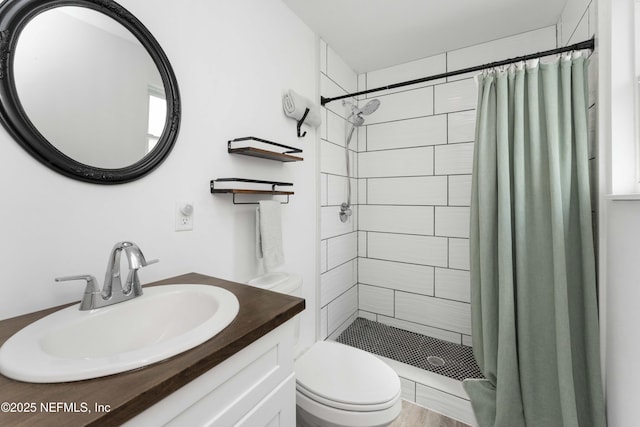 full bath featuring a shower stall, toilet, and vanity