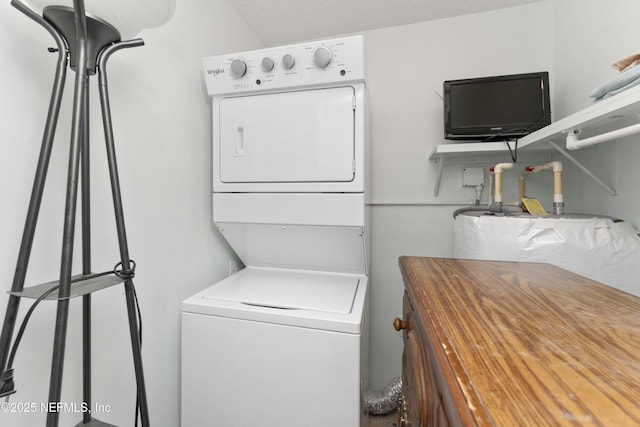 laundry room with stacked washer / drying machine