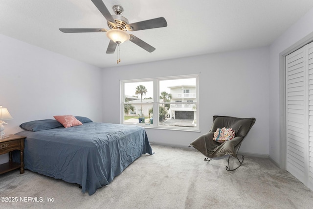 carpeted bedroom with a closet and a ceiling fan