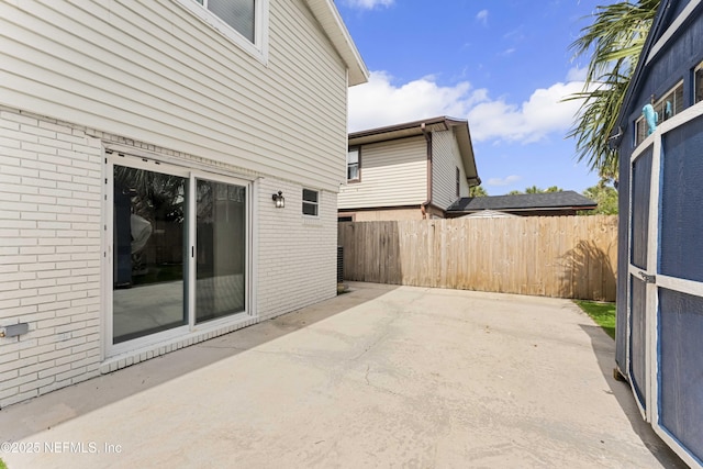 view of patio featuring fence