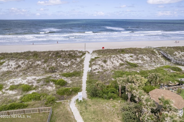 drone / aerial view featuring a view of the beach and a water view