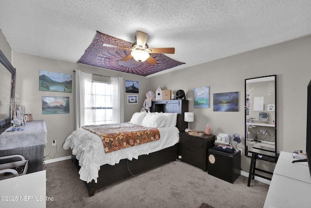 bedroom with carpet flooring, a ceiling fan, baseboards, and a textured ceiling