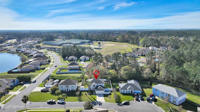 drone / aerial view featuring a residential view and a water view