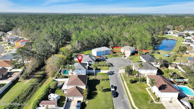 aerial view with a residential view, a water view, and a wooded view