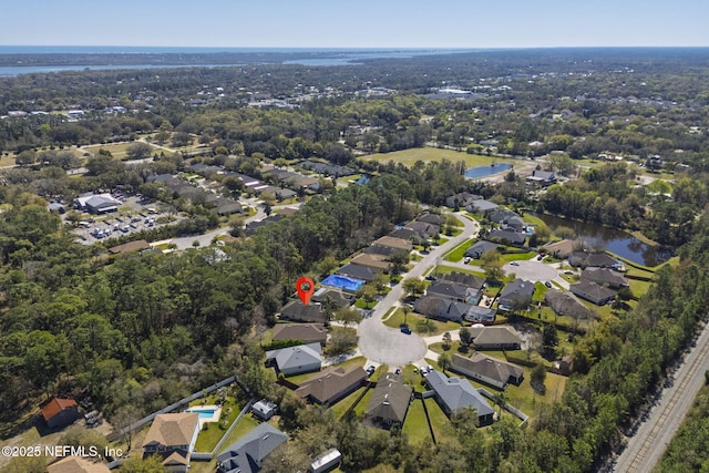 drone / aerial view featuring a residential view and a water view