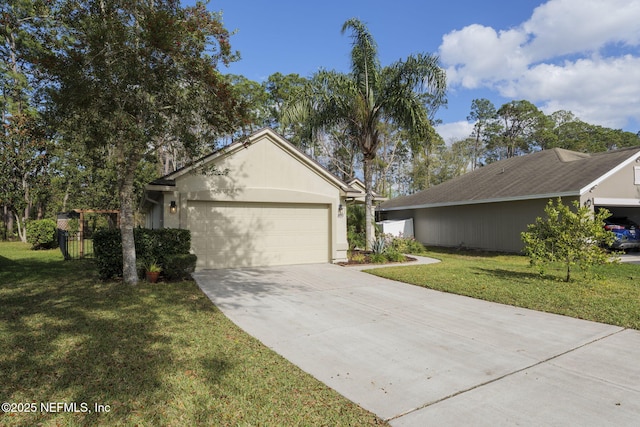 ranch-style home with a garage, concrete driveway, and a front yard