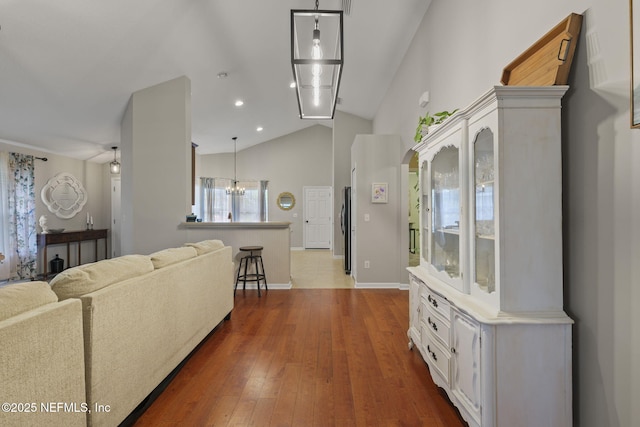 living room featuring dark wood finished floors, recessed lighting, baseboards, and lofted ceiling